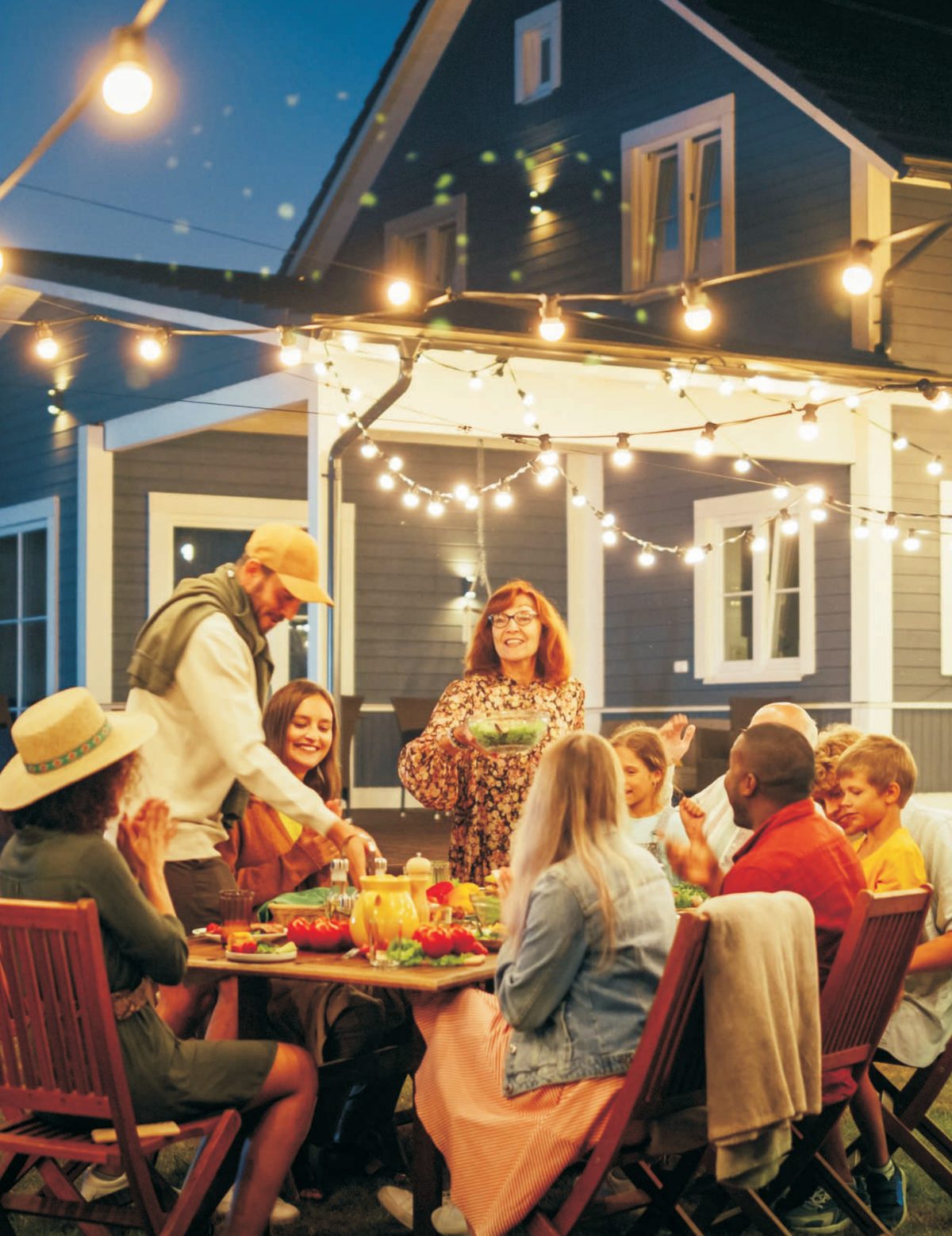 Family dinner around outdoor kitchen and motorised pergola